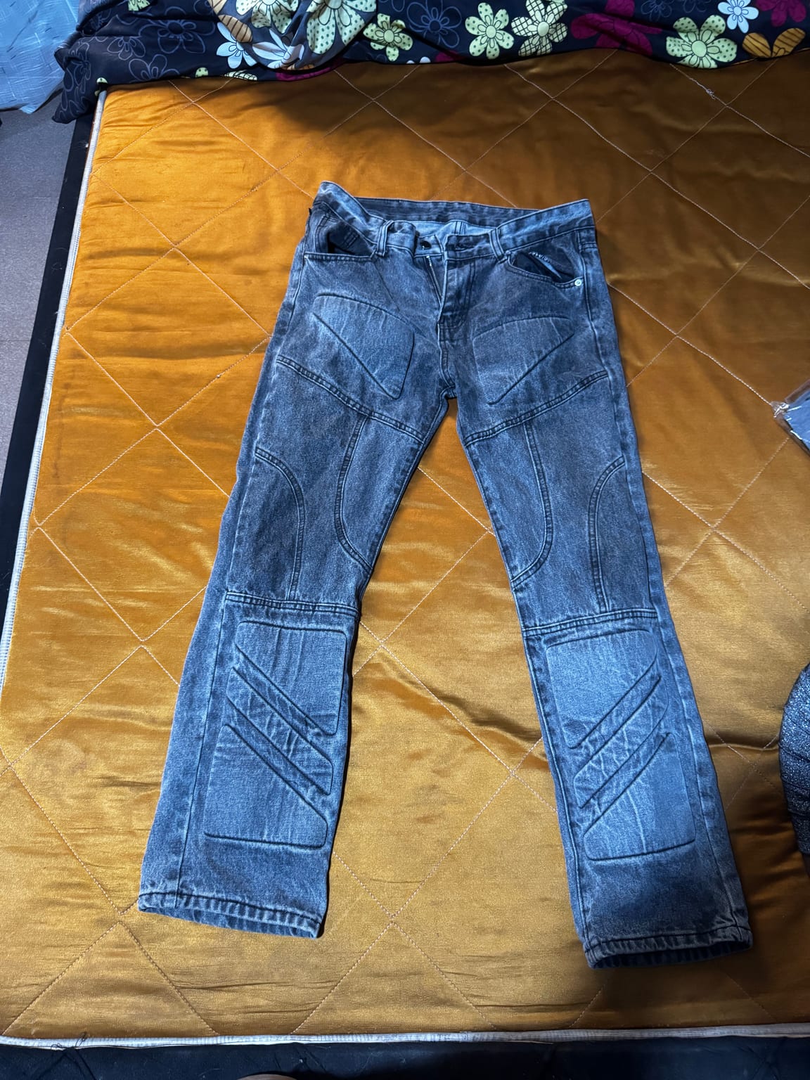 Features knee and thigh patches with distinct stitching.